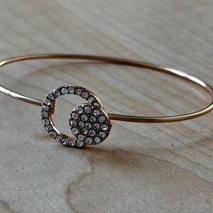 Very thin gold tone bracelet/ clear rhinestone clusters/ fits size 7 wrist